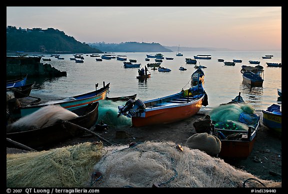 Fishing nets and boats, sunrise. Goa, India