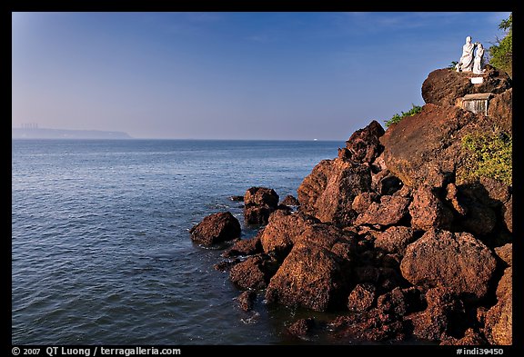 Boulders and christian statues at the edge of ocean, Dona Paula. Goa, India (color)
