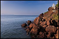 Boulders and christian statues at the edge of ocean, Dona Paula. Goa, India