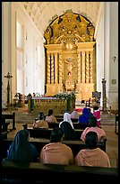 Indian women sitting in front of the altar, Basilica of Bom Jesus, Old Goa. Goa, India (color)