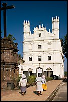 Women walking towards Church of St Francis of Assisi, afternoon, Old Goa. Goa, India