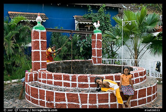 Woman and girls at communal well, Panjim. Goa, India