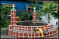 Woman and girls at communal well, Panjim. Goa, India