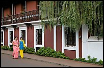 Women strolling past the heritage Panaji Inn, Panjim. Goa, India (color)