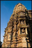 Bands of carved sculptures below spire (sikhara), Javari Temple, Eastern Group. Khajuraho, Madhya Pradesh, India (color)