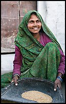 Woman sorting grains. Khajuraho, Madhya Pradesh, India