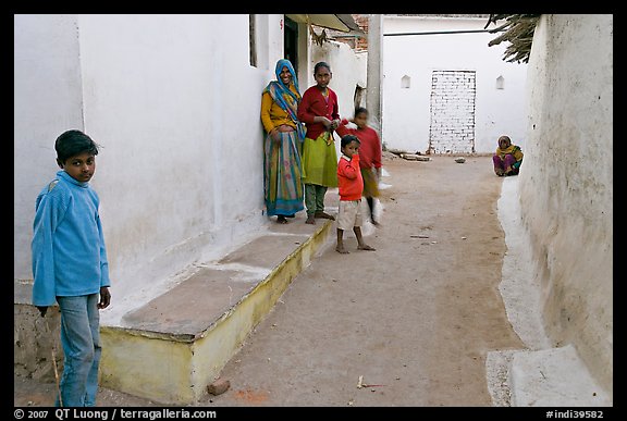 Family in village alley. Khajuraho, Madhya Pradesh, India