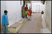 Family in village alley. Khajuraho, Madhya Pradesh, India