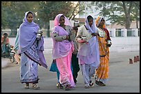 Hindu women walking in street with pots. Khajuraho, Madhya Pradesh, India ( color)