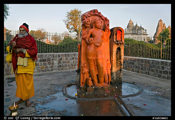 Holy man next to Shiva image. Khajuraho, Madhya Pradesh, India