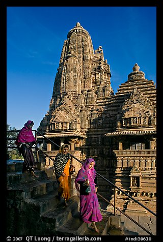 Women going down stairs in front of Lakshmana temple. Khajuraho, Madhya Pradesh, India (color)