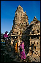 Women going down stairs in front of Lakshmana temple. Khajuraho, Madhya Pradesh, India ( color)