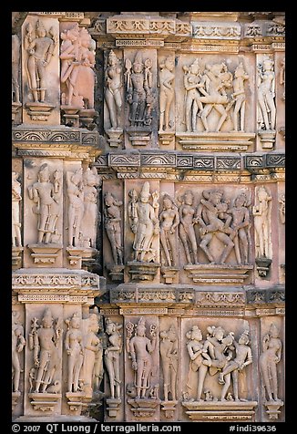 Carvings on the outside of Kadariya-Mahadeva temple including erotic figures. Khajuraho, Madhya Pradesh, India (color)