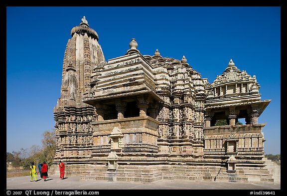 Devi Jagadamba temple with women walking. Khajuraho, Madhya Pradesh, India