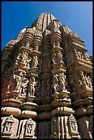Sculptures and sikhara of Devi Jagadamba temple from below. Khajuraho, Madhya Pradesh, India