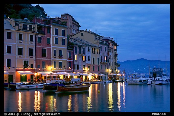 Houses reflected in harbor at dusk, Portofino. Liguria, Italy