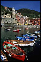 Colorful samll fishing boats in the harbor and main plaza, Vernazza. Cinque Terre, Liguria, Italy