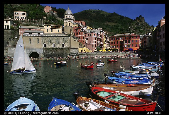 Colorful fishing boats in the harbor and Piazza Guglielmo Marconi, Vernazza. Cinque Terre, Liguria, Italy