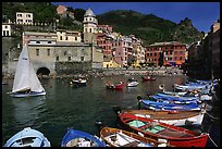 Colorful fishing boats in the harbor and Piazza Guglielmo Marconi, Vernazza. Cinque Terre, Liguria, Italy