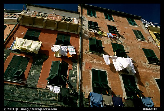 Typical terra cotta facade with clothelines and green shutters,  Vernazza. Cinque Terre, Liguria, Italy