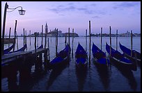 Parked gondolas, Canale della Guidecca, San Giorgio Maggiore church at dawn. Venice, Veneto, Italy