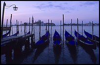 Parked gondolas, Canale della Guidecca, San Giorgio Maggiore church at dawn. Venice, Veneto, Italy (color)