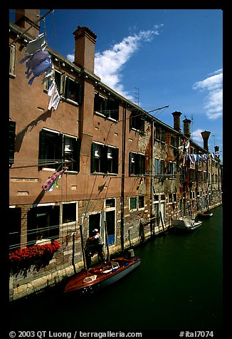 Resident stepping from his doorway to his boat,  Castello. Venice, Veneto, Italy (color)