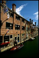 Resident stepping from his doorway to his boat,  Castello. Venice, Veneto, Italy ( color)