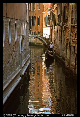 Gondola and reflections in a narrow canal. Venice, Veneto, Italy
