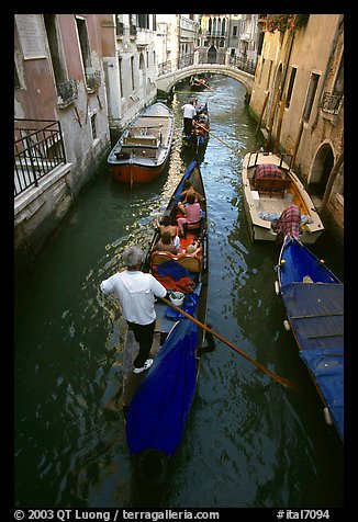 Gondolas lined up in narrow canal. Venice, Veneto, Italy