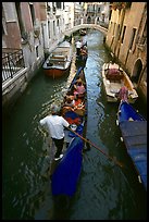 Gondolas lined up in narrow canal. Venice, Veneto, Italy