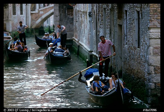 Several gondolas in a narrow canal. Venice, Veneto, Italy