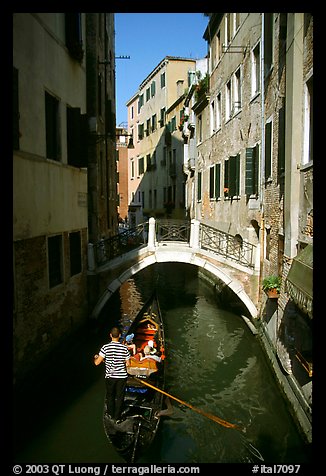 Gondola tour in a picturesque canal with bridge. Venice, Veneto, Italy