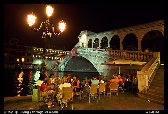 Outdoor cafe terrace,  Rialto Bridge at night. Venice, Veneto, Italy (color)