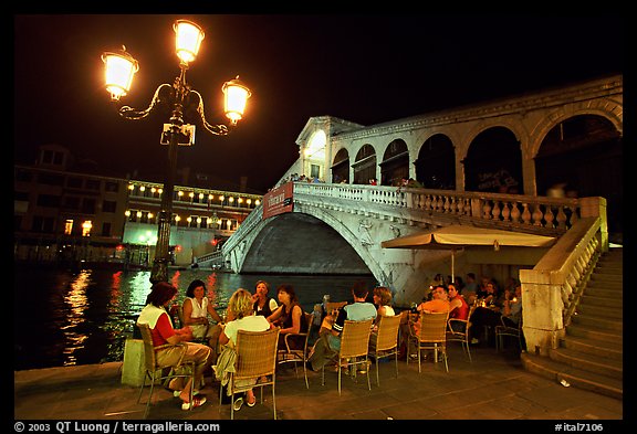 Outdoor cafe terrace,  Rialto Bridge at night. Venice, Veneto, Italy