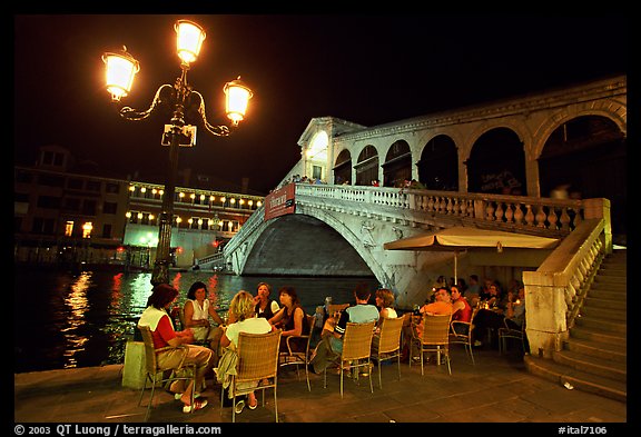 Outdoor cafe terrace,  Rialto Bridge at night. Venice, Veneto, Italy