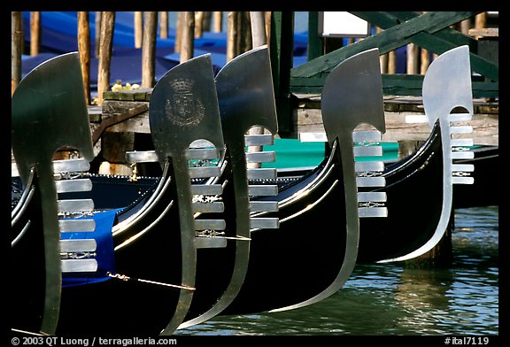 Row of gondolas prows, with their characteristic ferri. Venice, Veneto, Italy