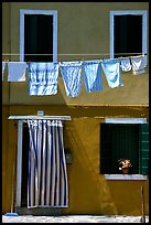 Hanging laundry and colored wall, Burano. Venice, Veneto, Italy (color)
