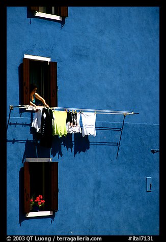 Windows, hanging laundry, blue house, Burano. Venice, Veneto, Italy