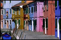 Sidewalk and row of brightly painted houses, Burano. Venice, Veneto, Italy (color)