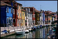 Canal lined with typical brightly painted houses, Burano. Venice, Veneto, Italy (color)