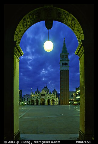 Campanile and Piazza San Marco (Square Saint Mark) seen from arcades at night. Venice, Veneto, Italy