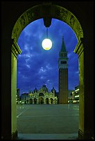 Campanile and Piazza San Marco (Square Saint Mark) seen from arcades at night. Venice, Veneto, Italy