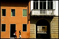 House facades with women walking. Veneto, Italy