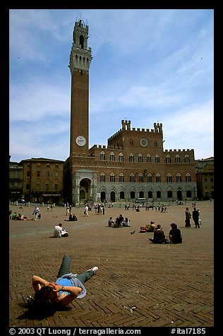 Tourist relaxes on Piazza Del Campo. Siena, Tuscany, Italy