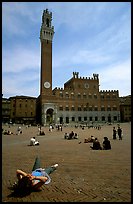 Tourist relaxes on Piazza Del Campo. Siena, Tuscany, Italy