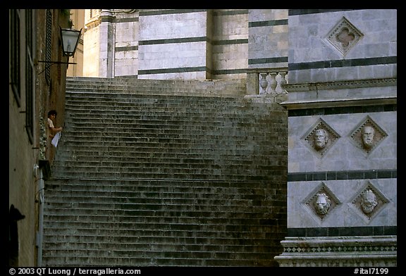 Woman cleaning up besides the Duomo stairs. Siena, Tuscany, Italy