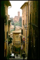 Narrow street with church in background. Siena, Tuscany, Italy