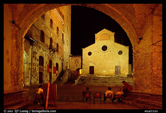 Duomo framed by an arch at night. San Gimignano, Tuscany, Italy