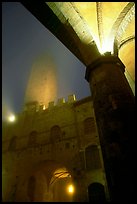 Medieval towers above Piazza del Duomo, foggy night. San Gimignano, Tuscany, Italy (color)